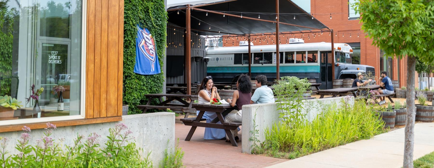a group of people sitting at a table outside a building